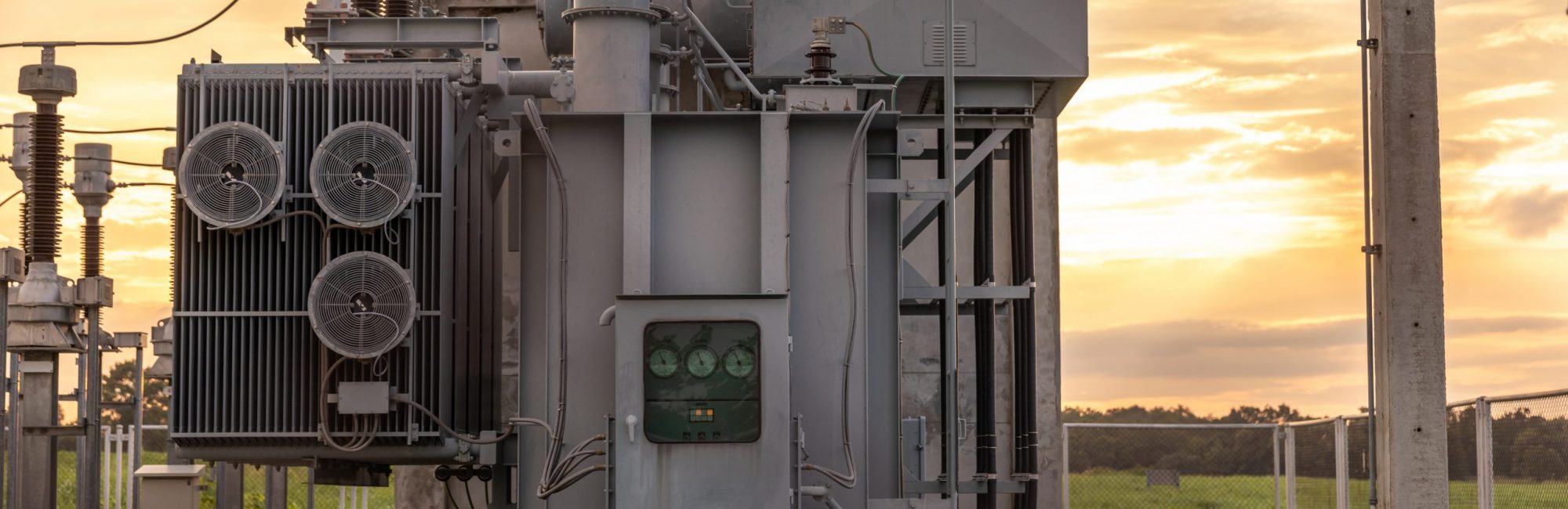 The transformer on a concrete pole. Three-phase transformers and rafts on rails for industrial plants. Transformer on concrete column beams.